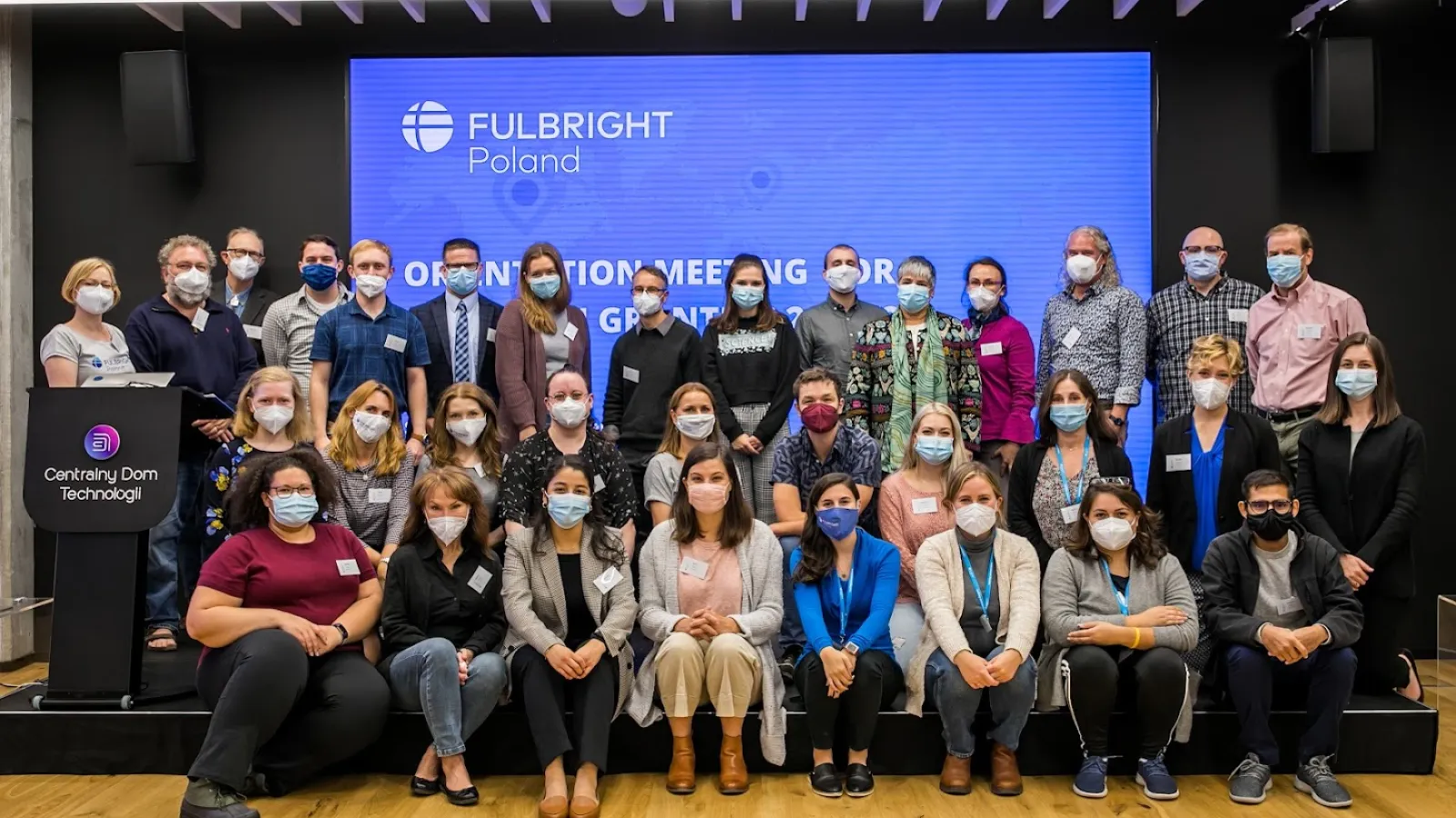 A group of people indoors wearing face masks