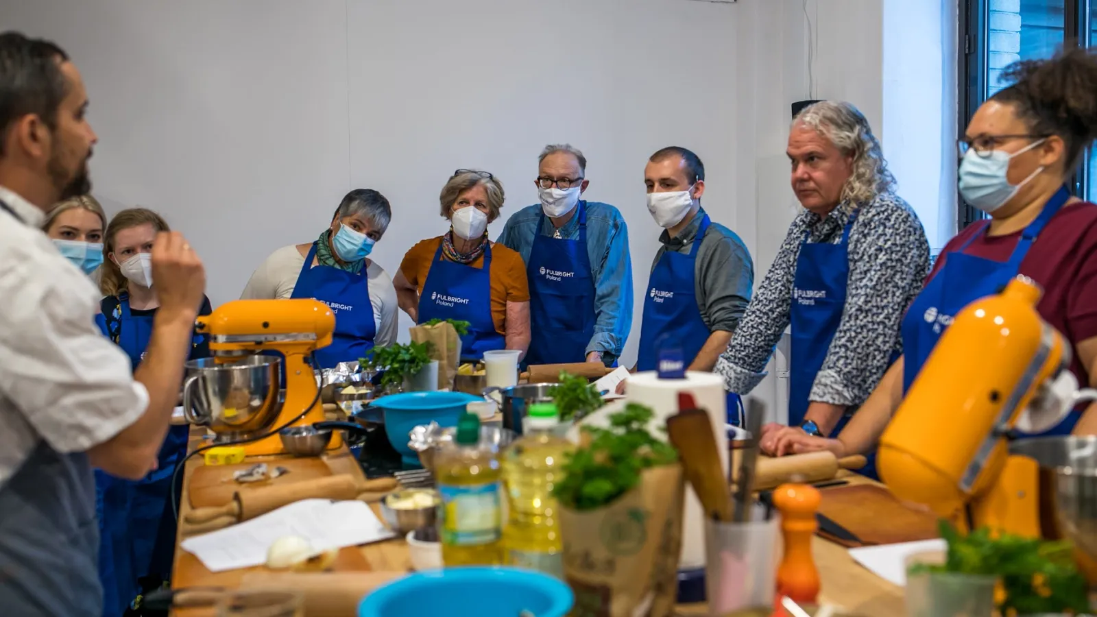 People looking at the cooking instructor
