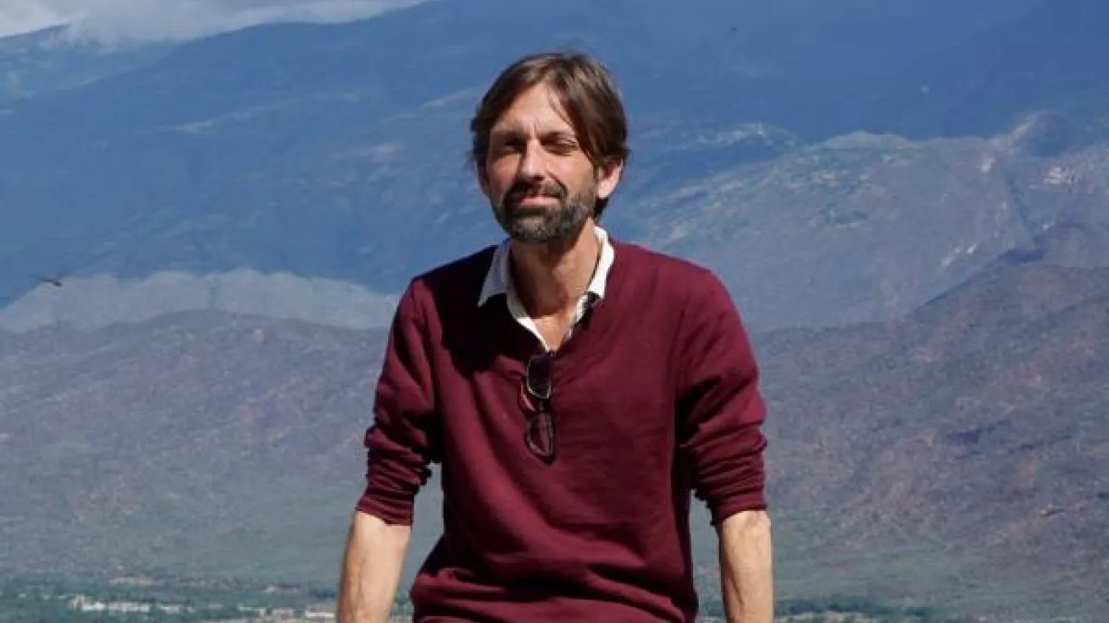 Hugh Urban sitting on a wall
