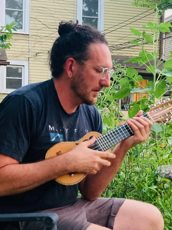 Seth with charango and plants
