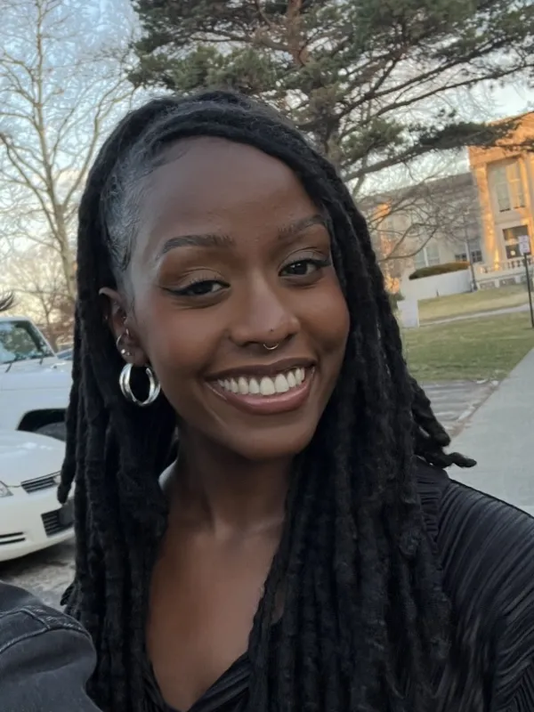 smiling in the park with silver hoops and hair half up and half down