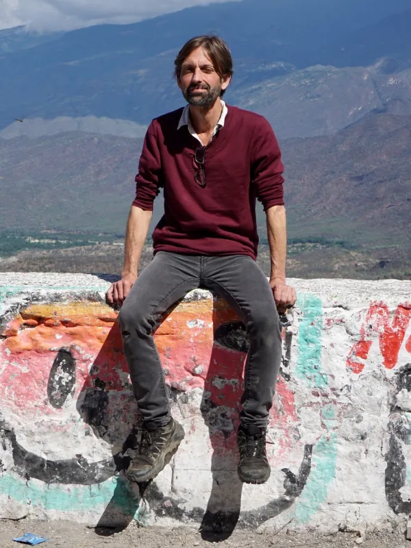 Hugh Urban sitting on a wall in Mexico